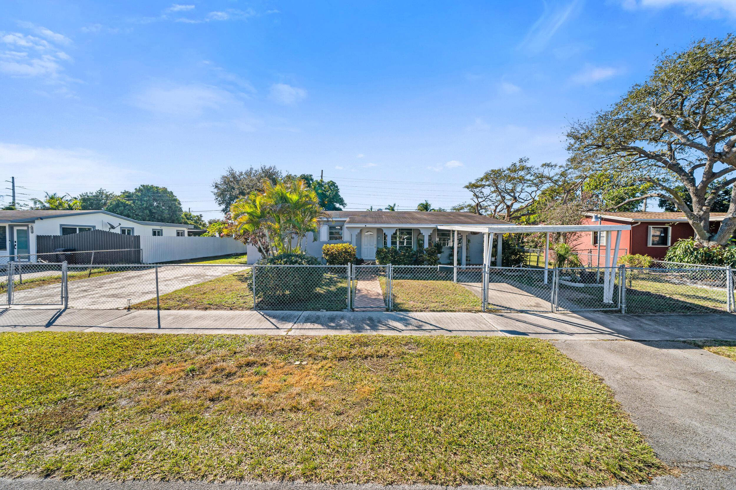 10730 Southwest 151st Street Miami, FL 33176 - Photo 2 of 26 a view of a swimming pool with an outdoor seating and a yard
