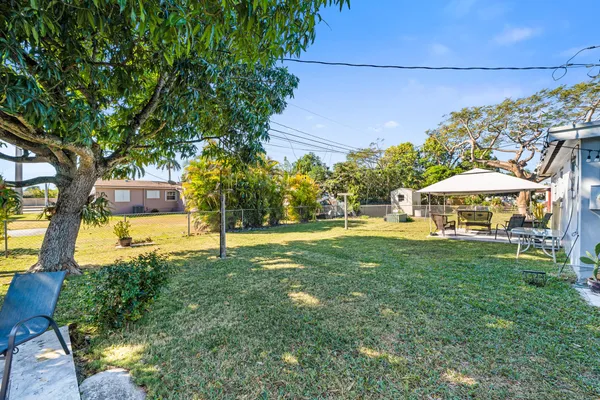 a view of a house with yard and sitting area