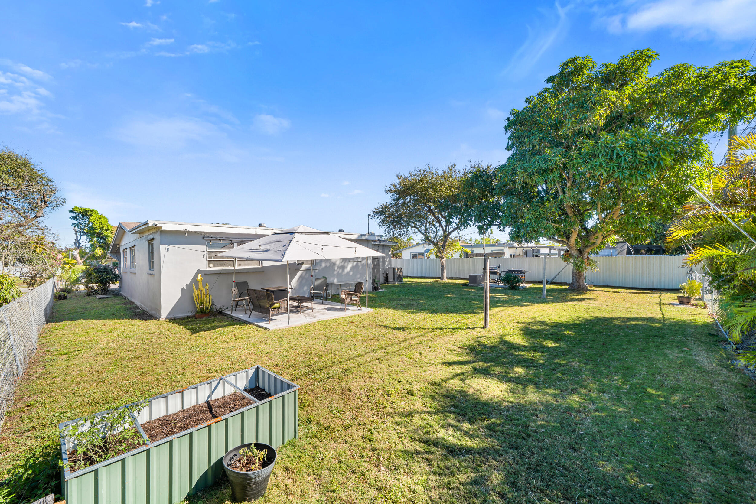 10730 Southwest 151st Street Miami, FL 33176 - Photo 24 of 26 a view of a house with yard and sitting area