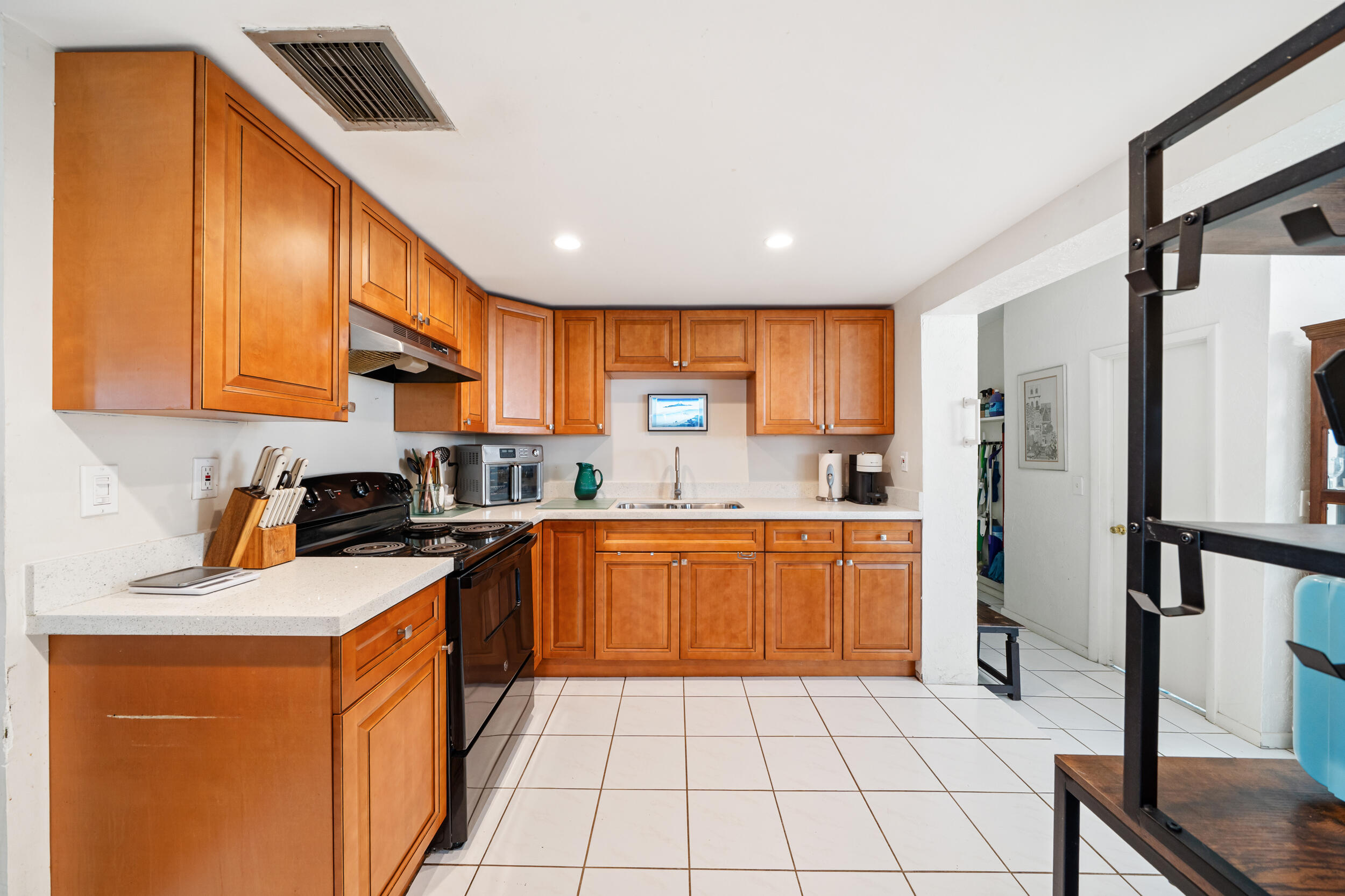 10730 Southwest 151st Street Miami, FL 33176 - Photo 9 of 26 a kitchen with stainless steel appliances granite countertop a sink refrigerator and cabinets