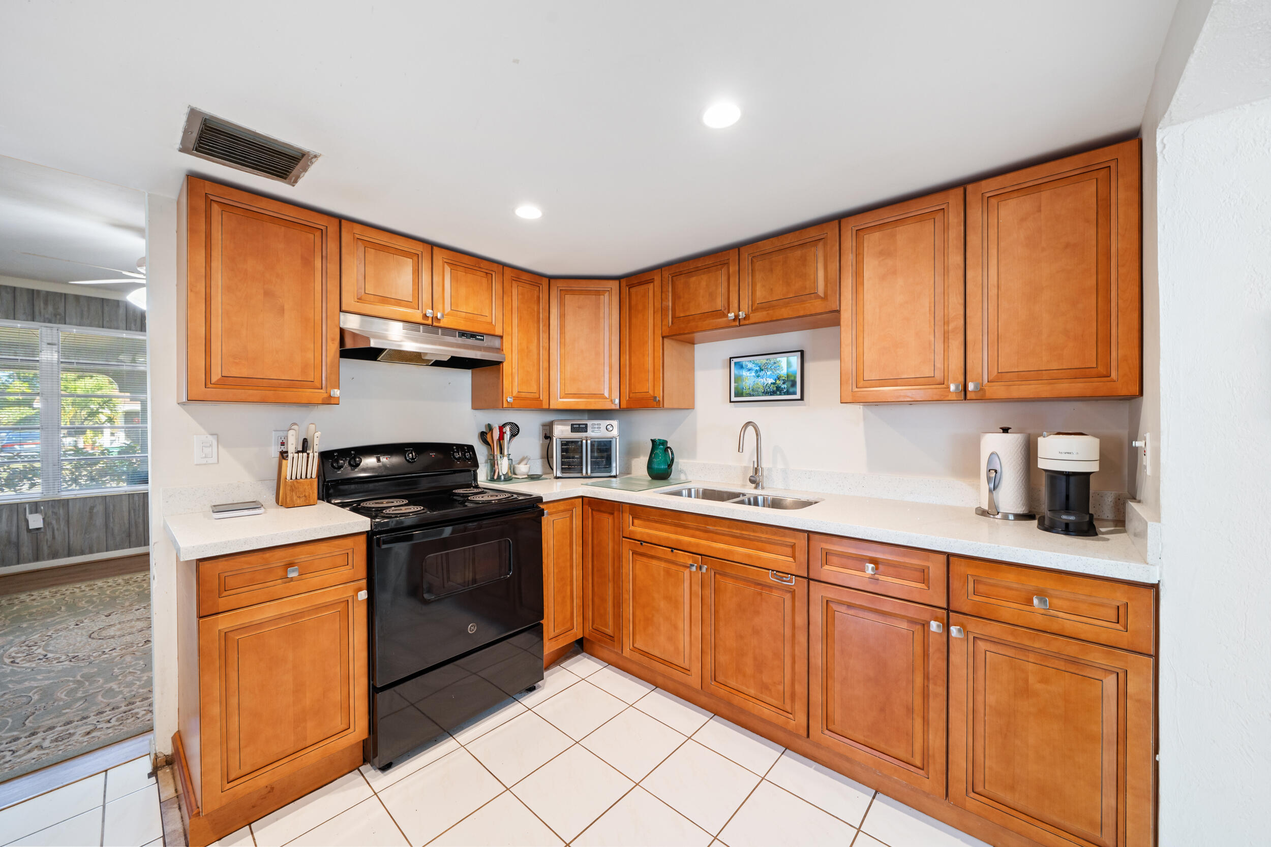10730 Southwest 151st Street Miami, FL 33176 - Photo 10 of 26 a kitchen with stainless steel appliances granite countertop a stove a sink dishwasher and a refrigerator