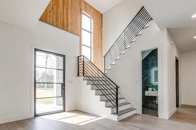 a view of staircase with white walls and a window