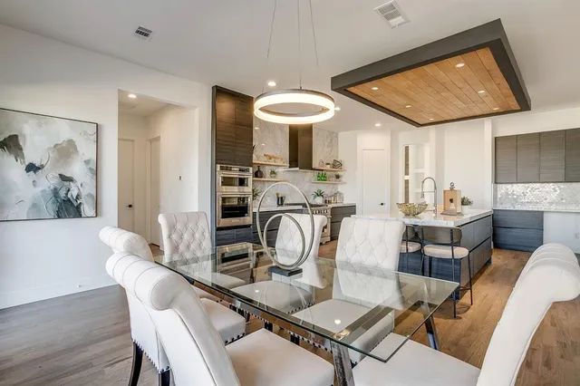 a view of a dining room with furniture and chandelier