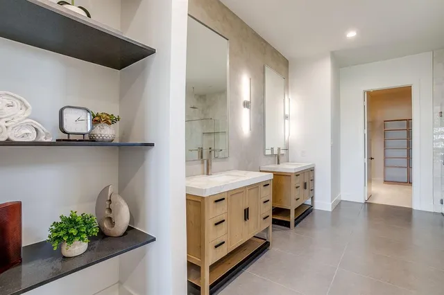 a bathroom with a double vanity sink and a mirror
