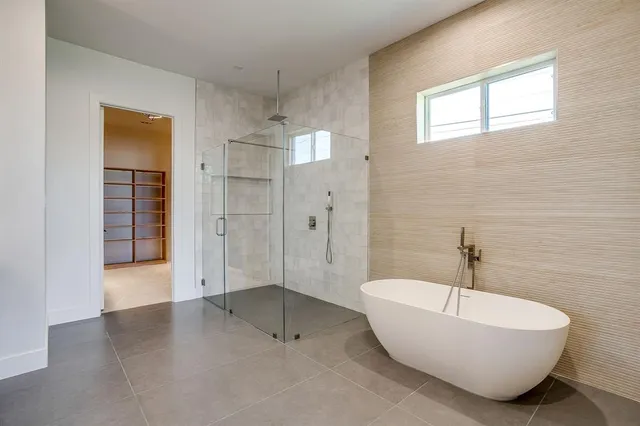 a spacious bathroom with a bathtub and shower