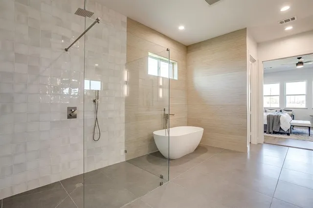 a bathroom with a bathtub and shower