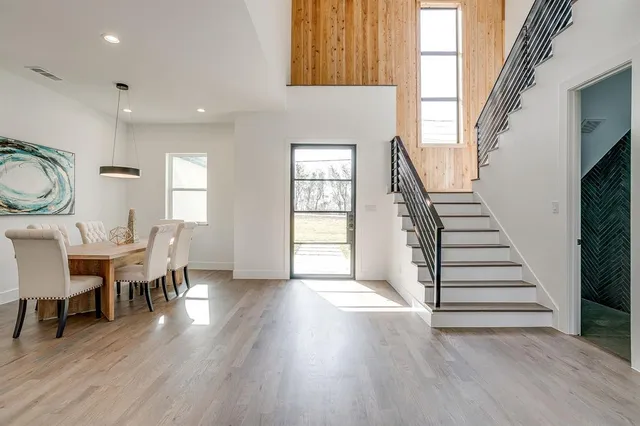 an entryway and livingroom with furniture wooden floor windows