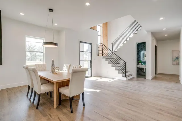 a view of a a dining room with furniture window and wooden floor