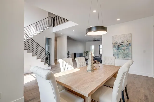 a dining room with furniture and wooden floor