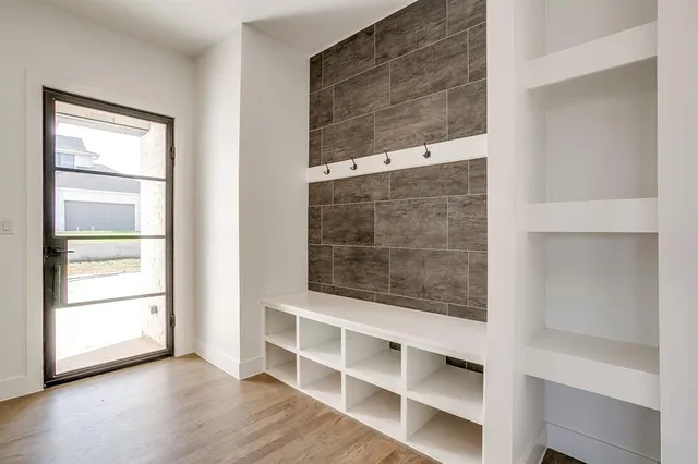 a view of a glass door with wooden floor