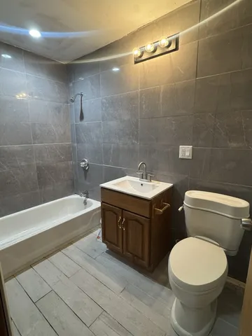 a bathroom with a sink toilet and bathtub