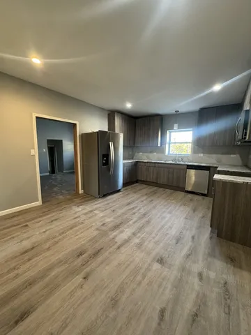 a view of a kitchen with a dishwasher and a refrigerator