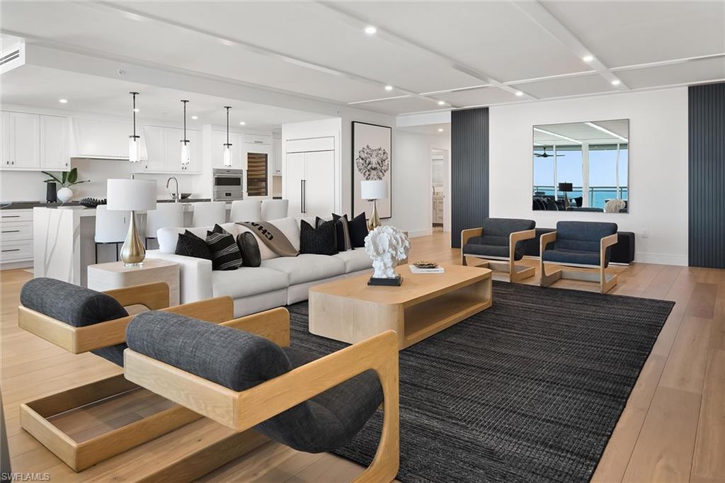 13935 Old Coast Road, Unit 2206 Naples, FL 34110 - Photo 13 of 50 The living room connects to dual hallways leading to the guest suites, laundry room, and den