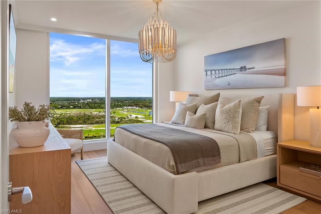 13935 Old Coast Road, Unit 2206 Naples, FL 34110 - Photo 16 of 50 The north wing leads to a furnished king-size guest bedroom with impact windows showcasing spectacular Kinsale Golf Club views