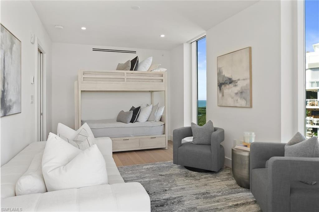 13935 Old Coast Road, Unit 2206 Naples, FL 34110 - Photo 19 of 50 Versatile end-unit den with bunk beds and floor-to-ceiling windows overlooking the Gulf of Mexico