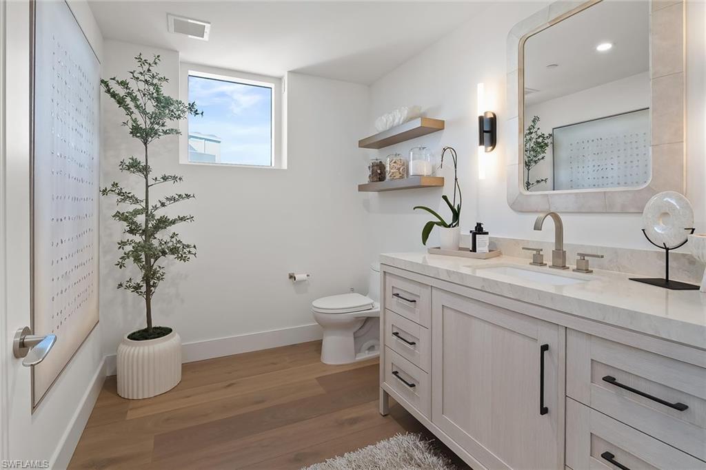 13935 Old Coast Road, Unit 2206 Naples, FL 34110 - Photo 20 of 50 Elegant powder room enhanced by a Gulf-view window and beautiful natural light.