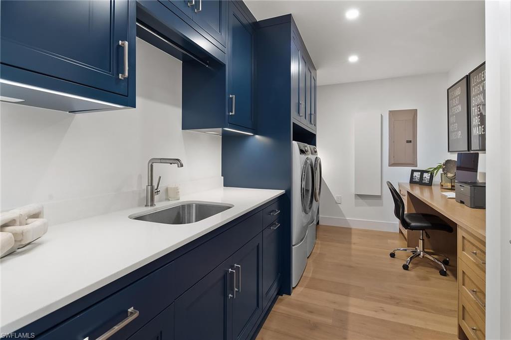 13935 Old Coast Road, Unit 2206 Naples, FL 34110 - Photo 22 of 50 Laundry room designed with custom cabinetry, quartz surfaces, an Iron-A-Way, and a utility closet