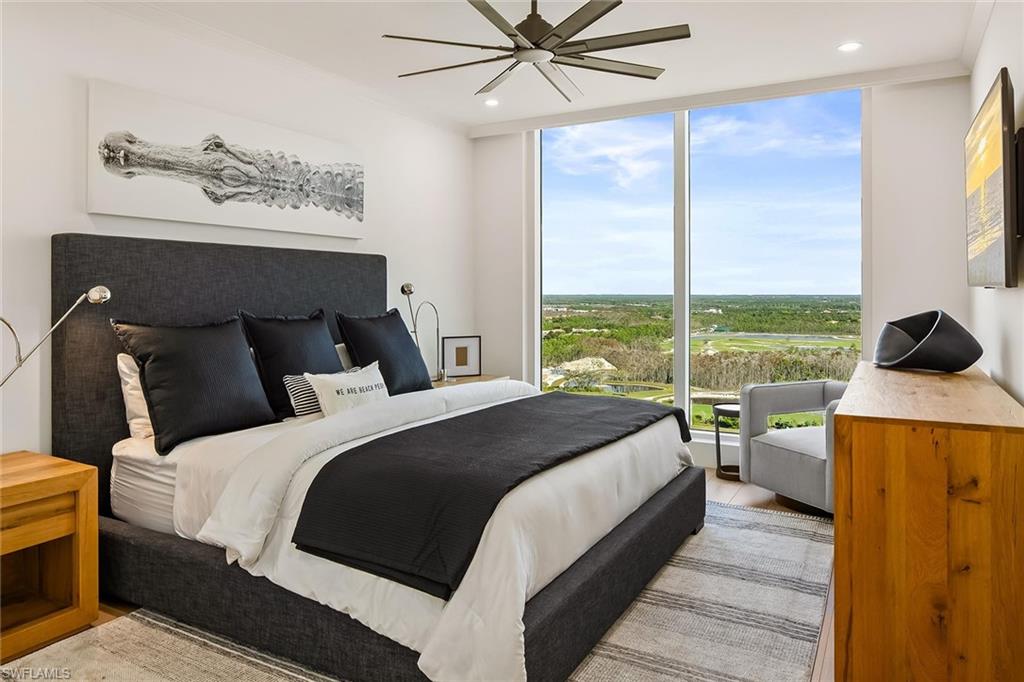 13935 Old Coast Road, Unit 2206 Naples, FL 34110 - Photo 24 of 50 Furnished king-size guest suite featuring floor-to-ceiling windows and serene Kinsale golf views.