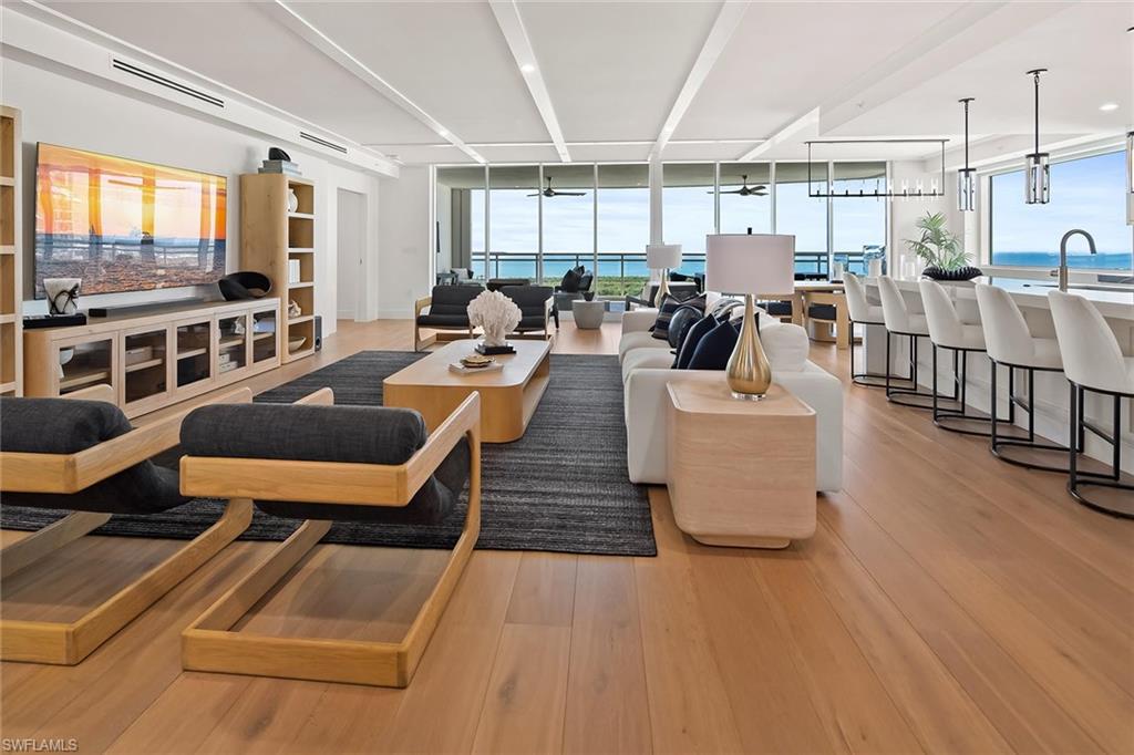 13935 Old Coast Road, Unit 2206 Naples, FL 34110 - Photo 26 of 50 Open living featuring custom RH furnishings, wood ceiling detailing, and hardwood floors throuhout