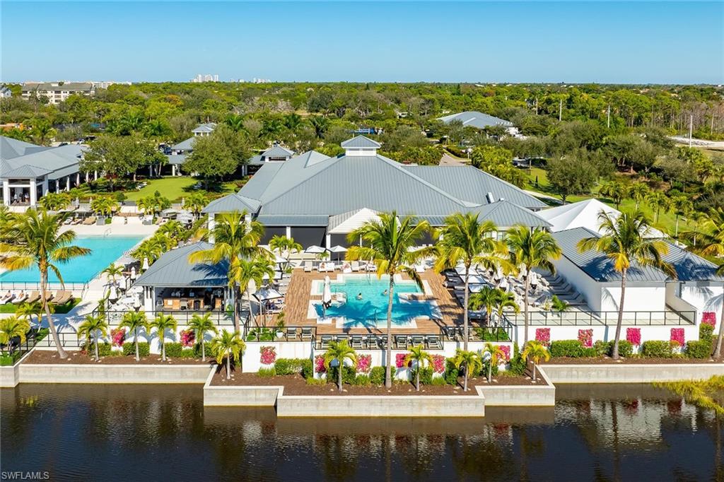 13935 Old Coast Road, Unit 2206 Naples, FL 34110 - Photo 33 of 50 Aerial of Lap Pool and Adult Pool with towel and food and beverage service, Tikki Hut Bar, Dining