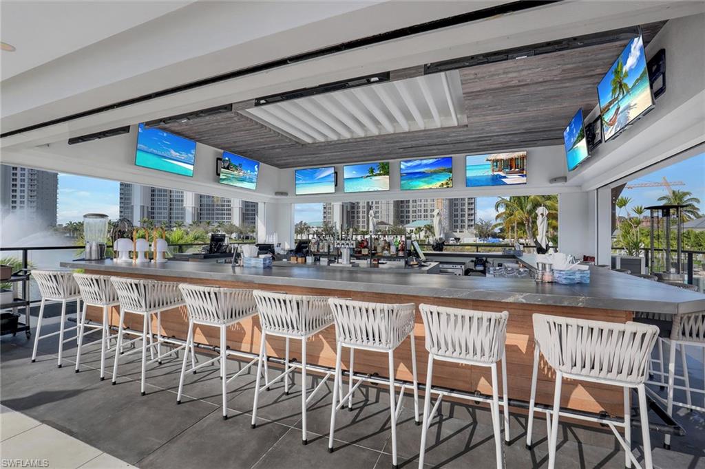13935 Old Coast Road, Unit 2206 Naples, FL 34110 - Photo 38 of 50 Open-air tiki bar where residents gather to watch the game, enjoy a drink, share a meal, and relax