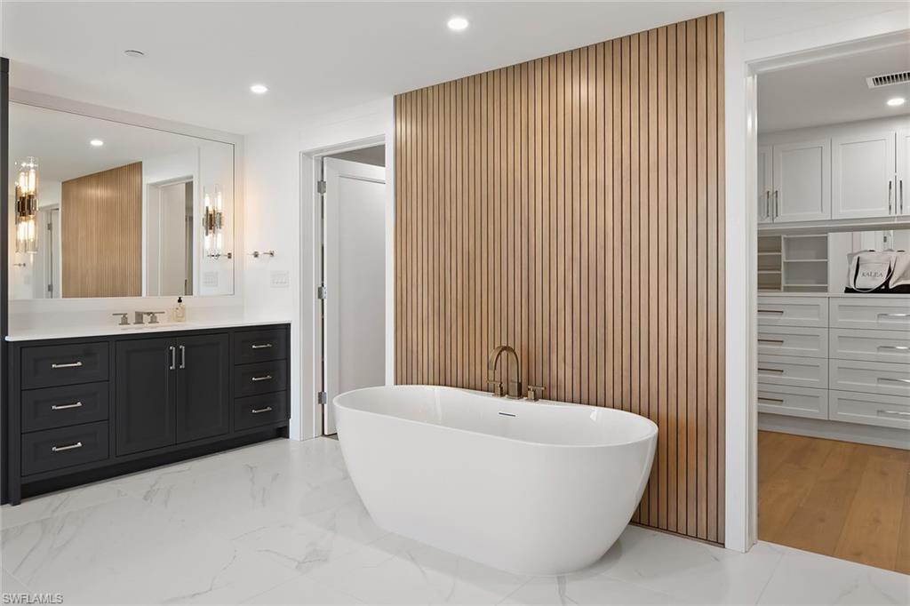13935 Old Coast Road, Unit 2206 Naples, FL 34110 - Photo 47 of 50 Freestanding Soaking Tub with Wood Accent Wall