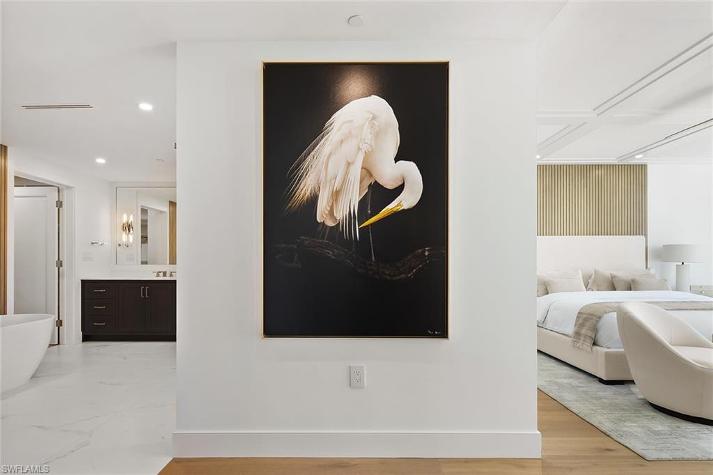 13935 Old Coast Road, Unit 2206 Naples, FL 34110 - Photo 8 of 50 Entry foyer into the primary suite, highlighted by striking Dennis Goodman art -All furnishings, decor' and artwork are included.