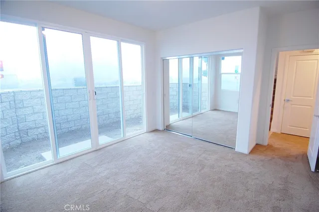 an empty room with sliding glass door