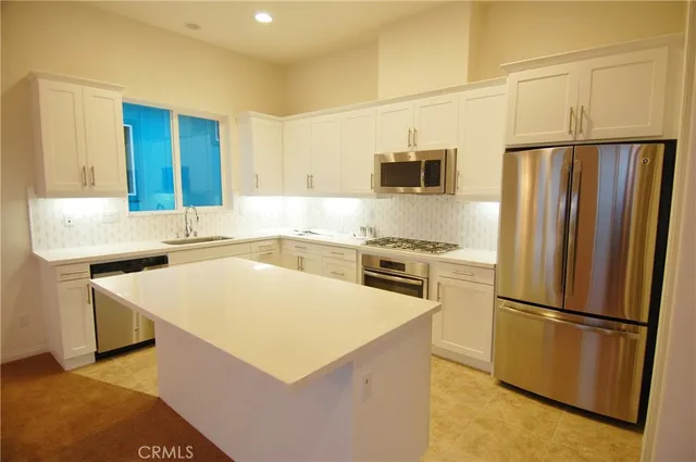 a kitchen with a refrigerator a stove top oven and a refrigerator