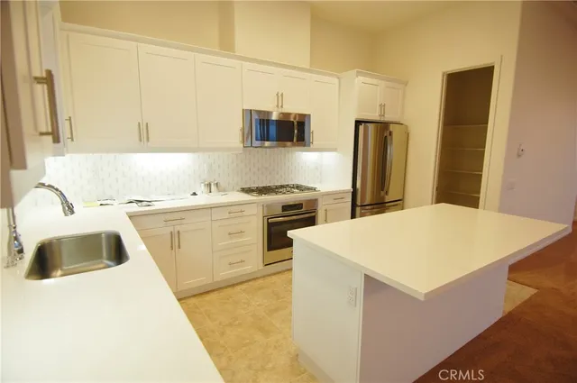 a kitchen with a sink a stove and refrigerator