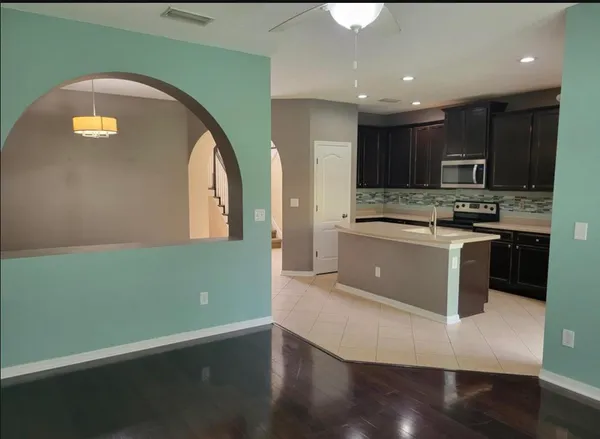 a kitchen with kitchen island a sink appliances and cabinets