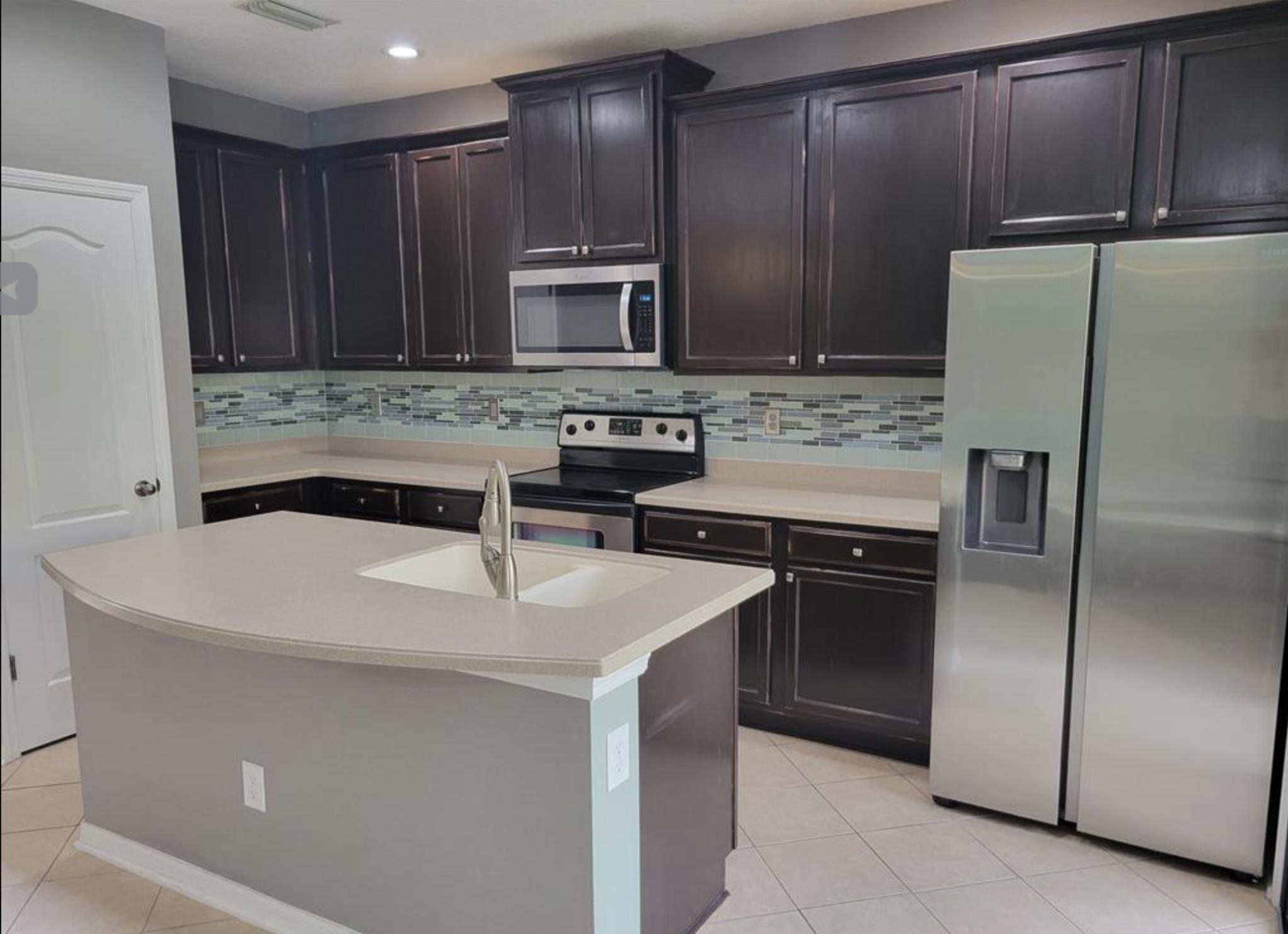 5 Rachel Court St. Augustine, FL 32080 - Photo 7 of 15 a kitchen with kitchen island a sink appliances and cabinets