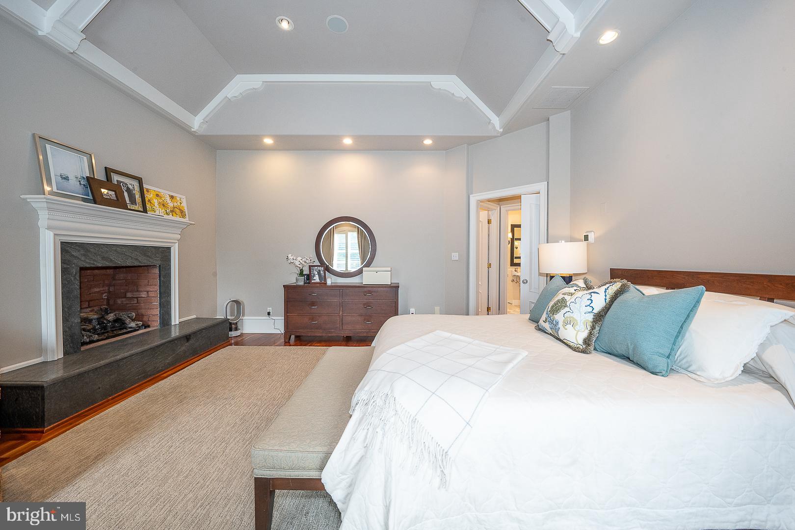1122 Brynlawn Road Villanova, PA 19085 - Photo 11 of 46 a bedroom with a large bed and a fireplace