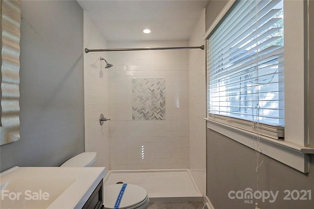 4001 Brookview Drive Charlotte, NC 28205 - Photo 13 of 16 a bathroom with a shower and a toilet