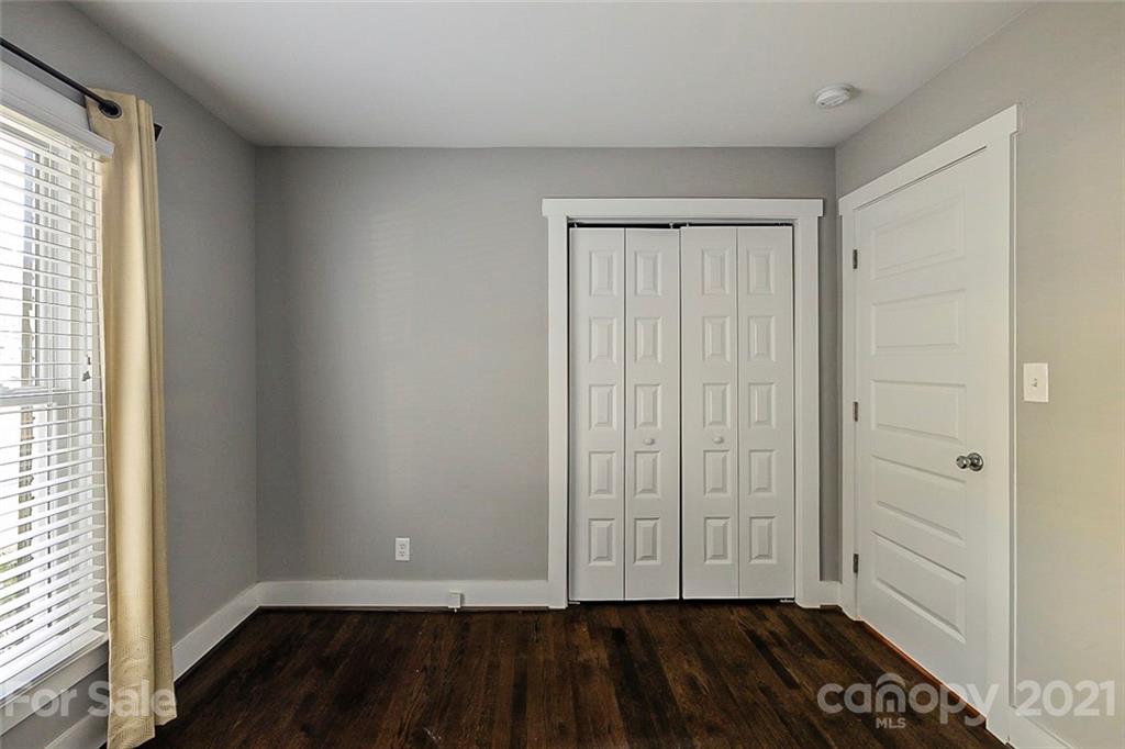 4001 Brookview Drive Charlotte, NC 28205 - Photo 16 of 16 an empty room with wooden floor and cabinet