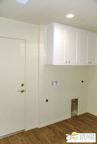 a view of a room with wooden floor and cabinet