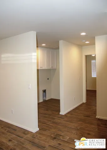 a view of hallway with wooden floor