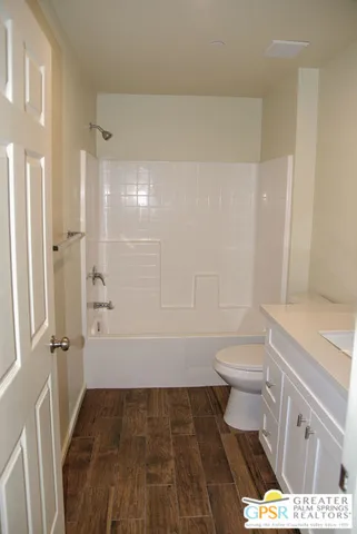 a bathroom with a toilet a sink and shower