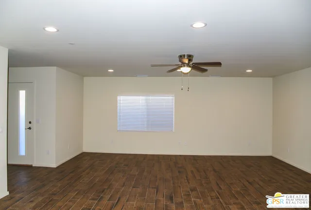 a view of an empty room and wooden floor