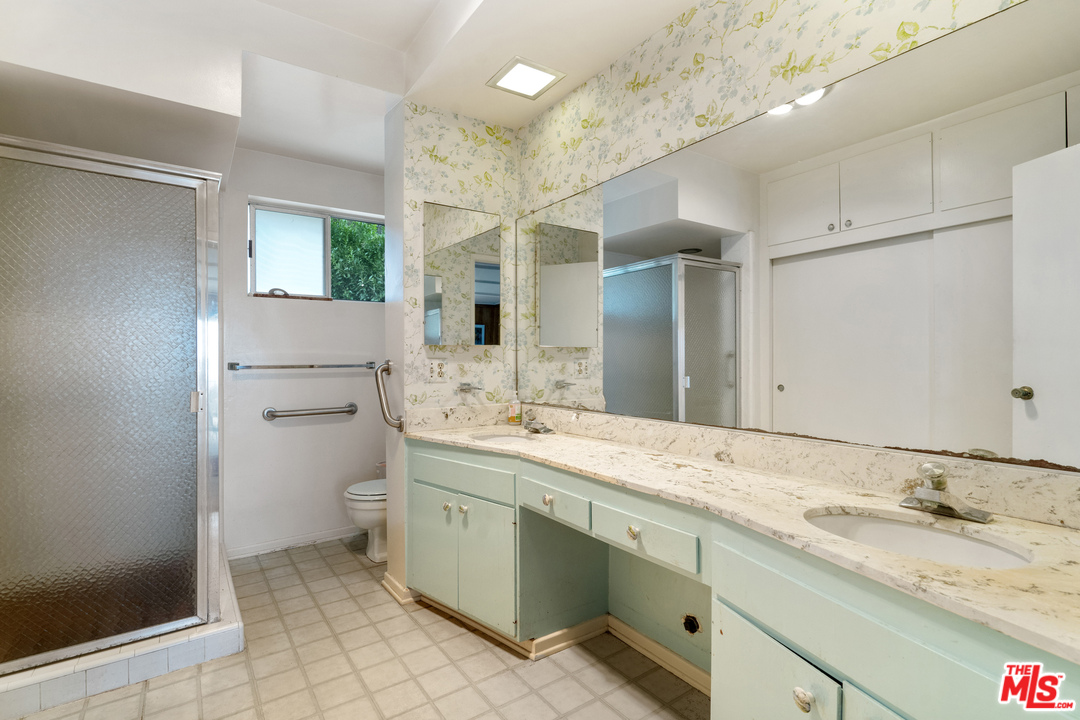 20734 Las Flores Mesa Drive Malibu, CA 90265 - Photo 11 of 23 a bathroom with a granite countertop sink mirror and toilet
