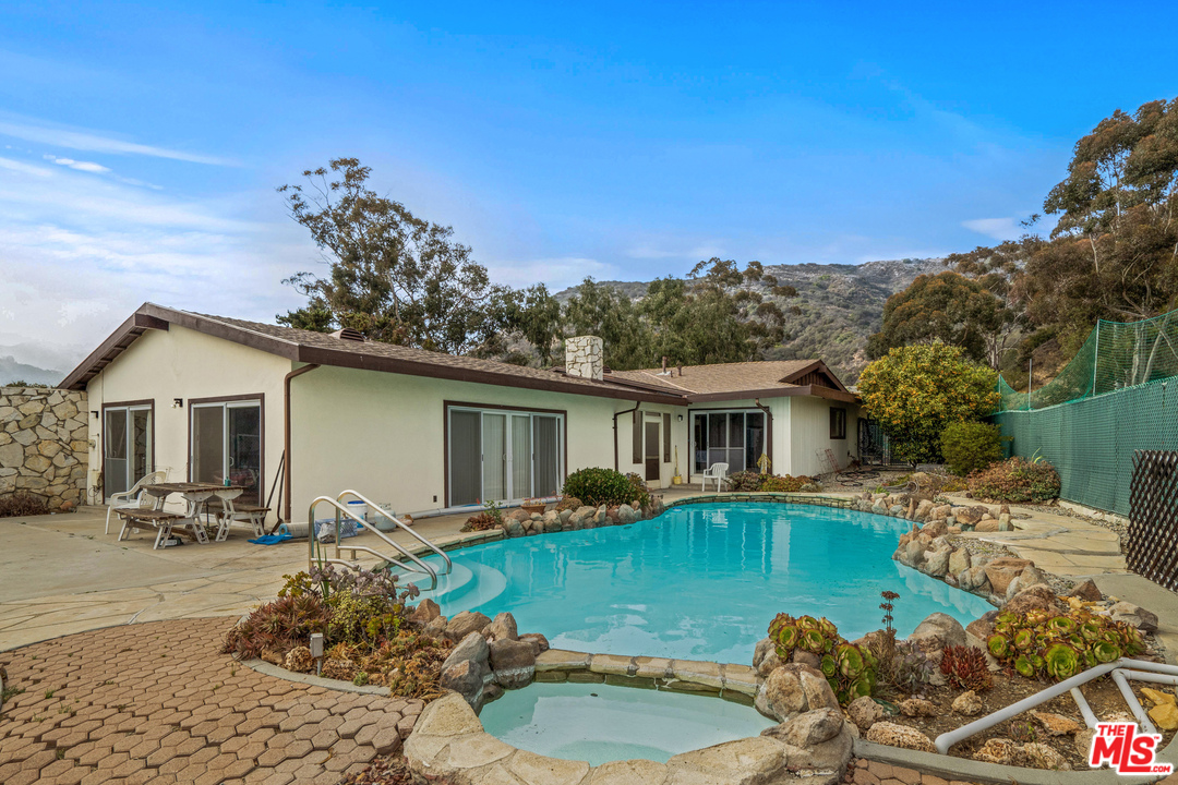 20734 Las Flores Mesa Drive Malibu, CA 90265 - Photo 3 of 23 a front view of a house with garden