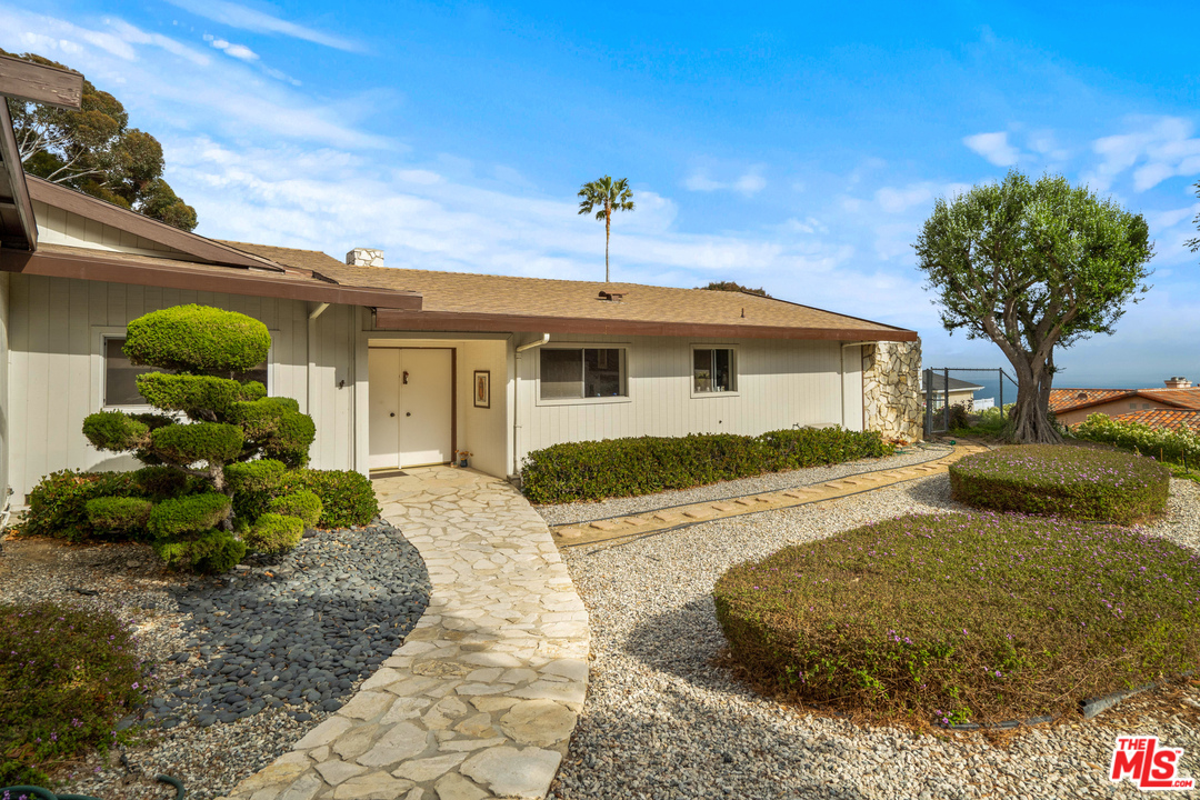 20734 Las Flores Mesa Drive Malibu, CA 90265 - Photo 5 of 23 a front view of a house with garden