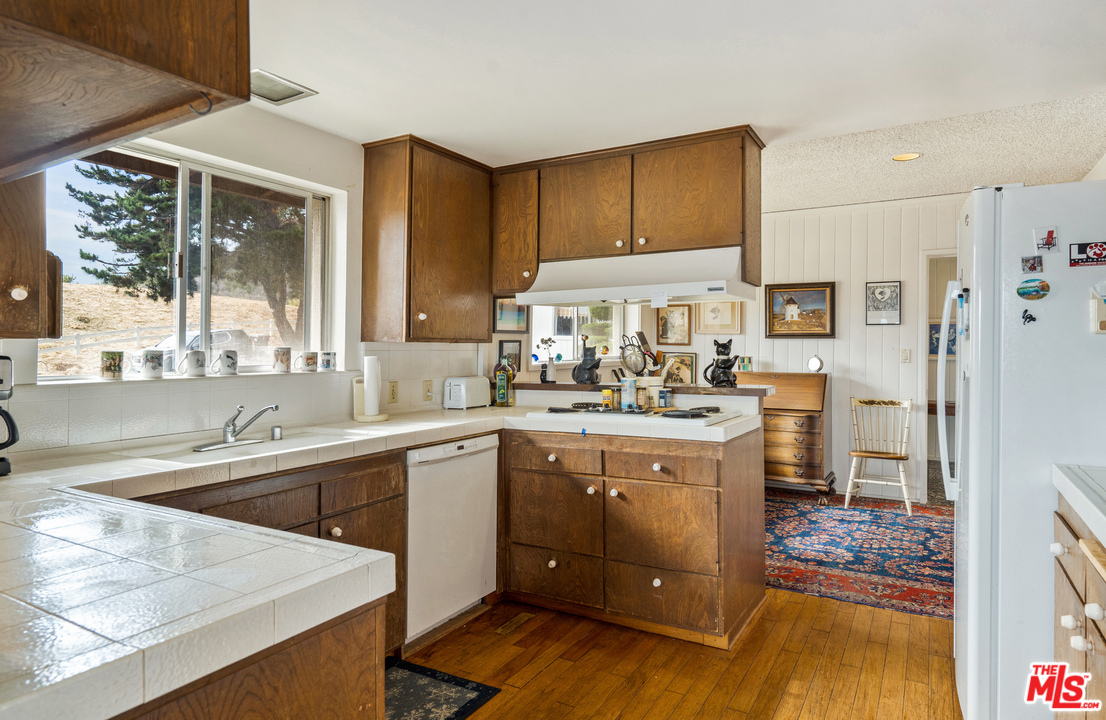 20734 Las Flores Mesa Drive Malibu, CA 90265 - Photo 8 of 23 a kitchen with a sink stove and refrigerator