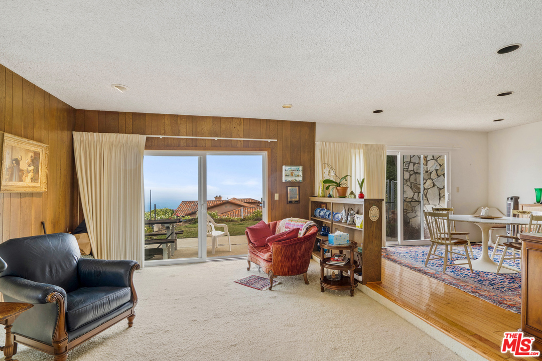20734 Las Flores Mesa Drive Malibu, CA 90265 - Photo 9 of 23 a living room with furniture and a flat screen tv