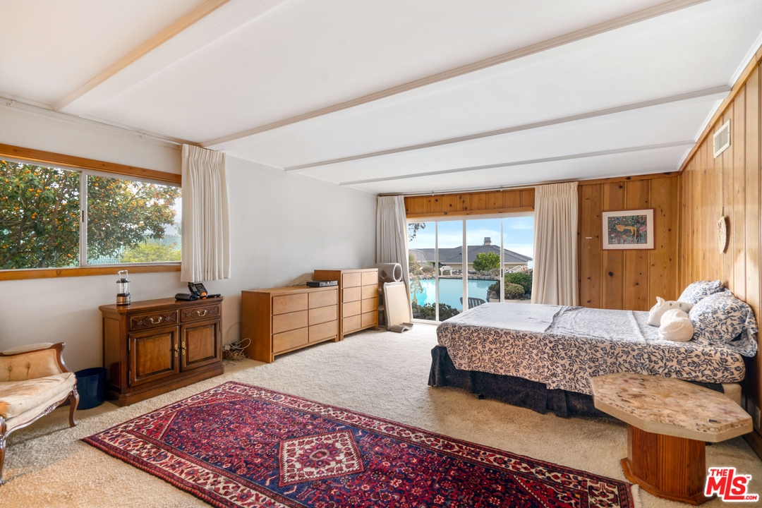 20734 Las Flores Mesa Drive Malibu, CA 90265 - Photo 10 of 23 a bedroom with a bed and large windows
