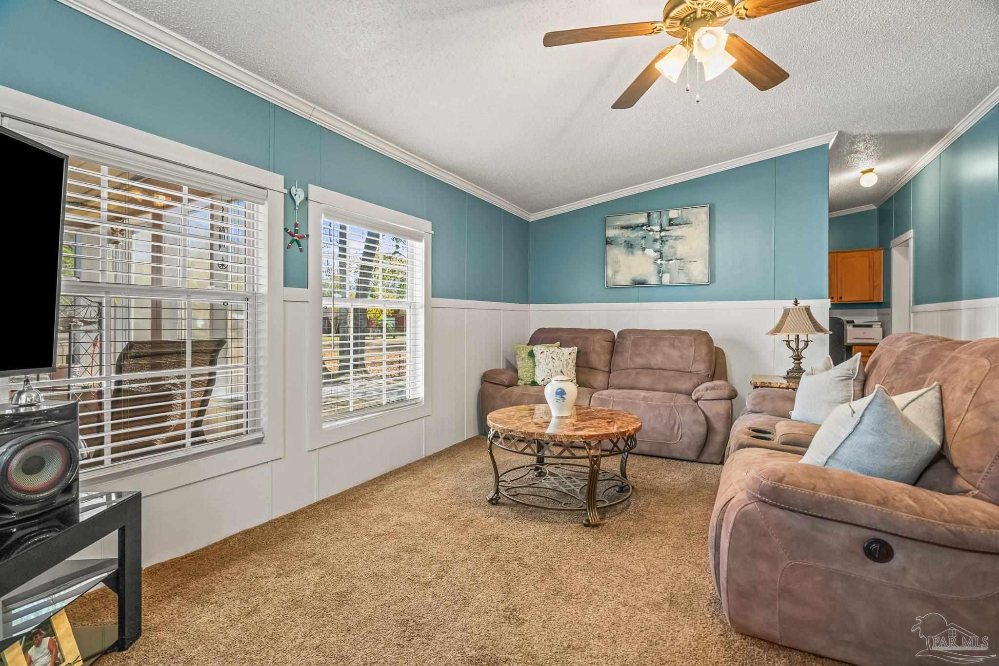 5105 April Lane Pace, FL 32571 - Photo 11 of 57 a living room with furniture and a flat screen tv