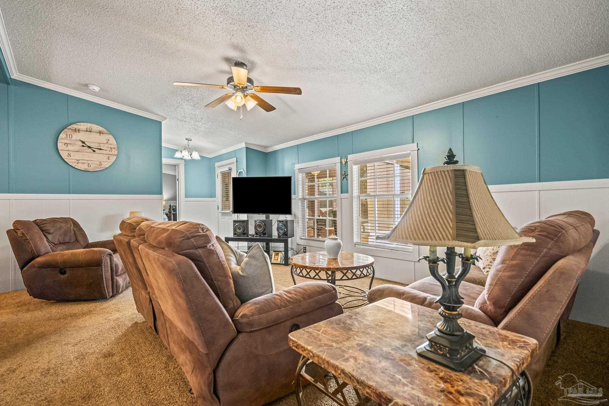5105 April Lane Pace, FL 32571 - Photo 12 of 57 a living room with furniture and a flat screen tv