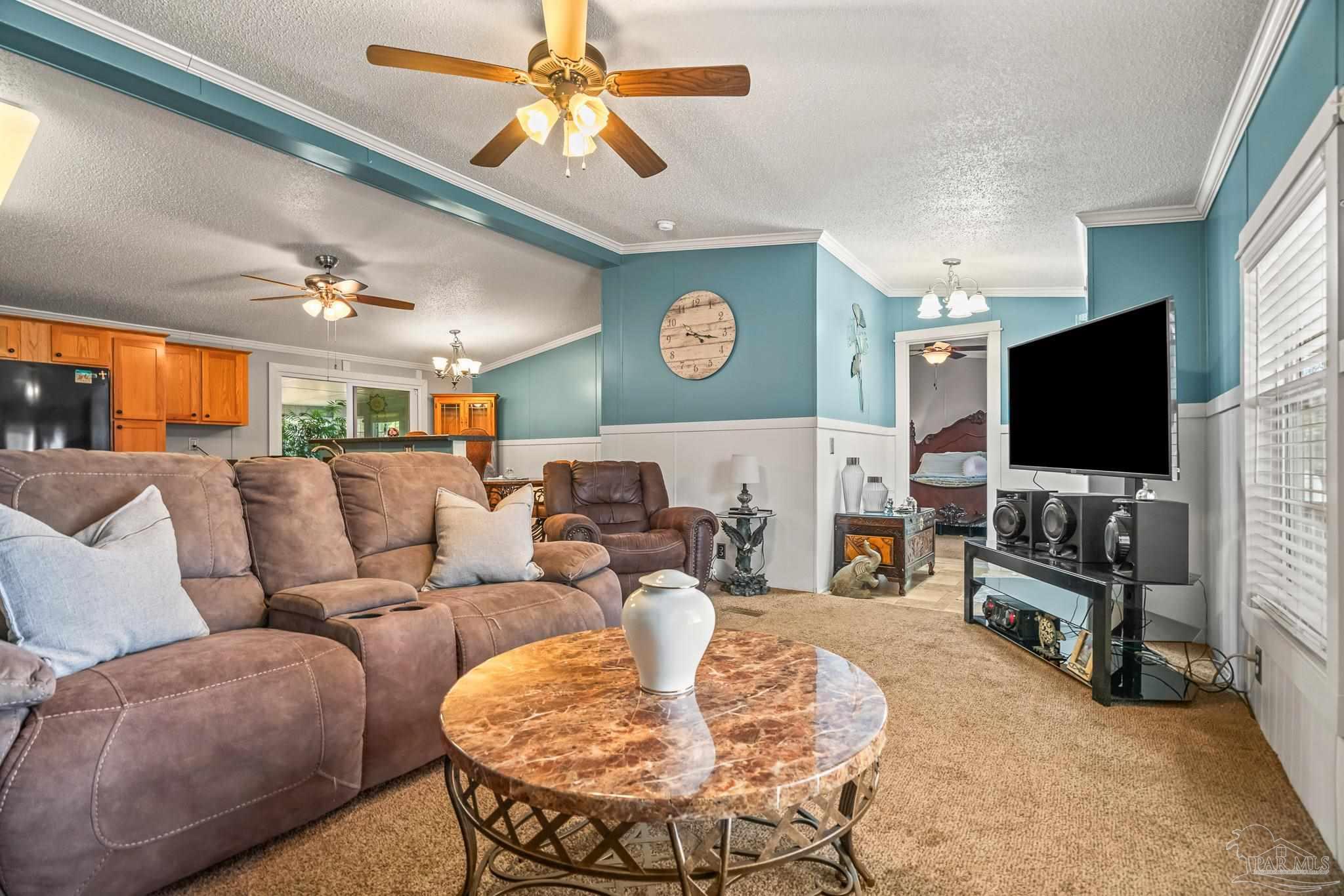 5105 April Lane Pace, FL 32571 - Photo 13 of 57 a living room with furniture and a flat screen tv