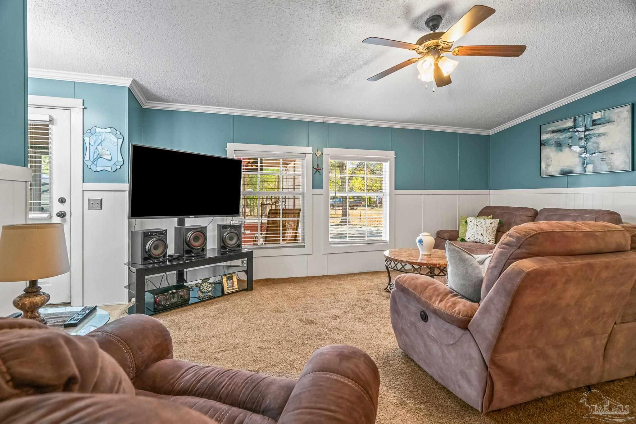 5105 April Lane Pace, FL 32571 - Photo 14 of 57 a living room with furniture and a flat screen tv
