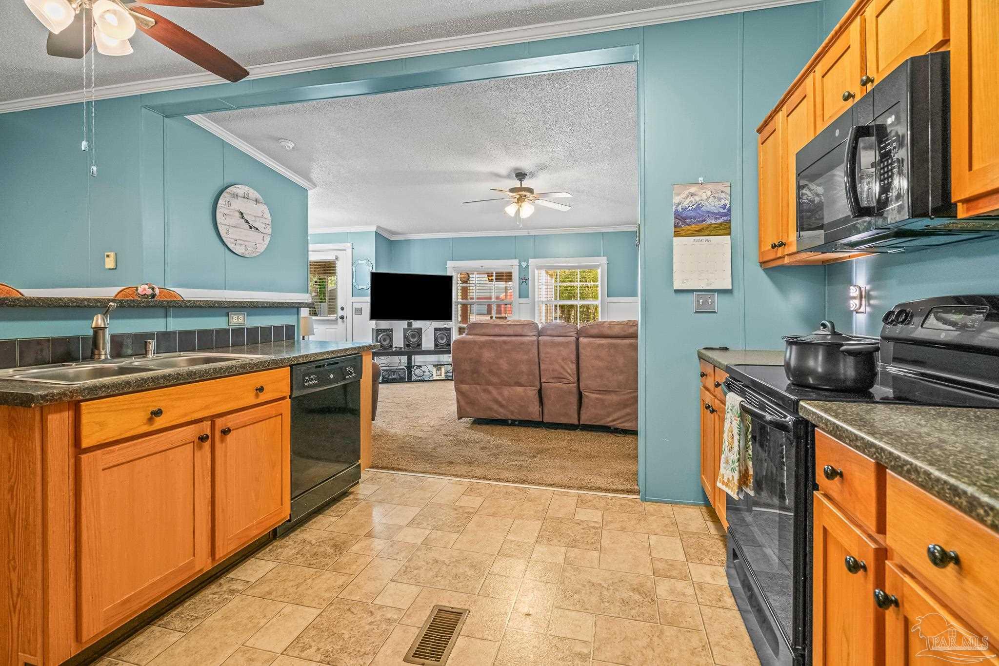 5105 April Lane Pace, FL 32571 - Photo 17 of 57 a kitchen with stainless steel appliances granite countertop a stove and a sink